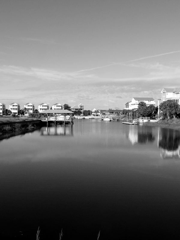 A residential boating canal lined with concrete seawalls and private docks